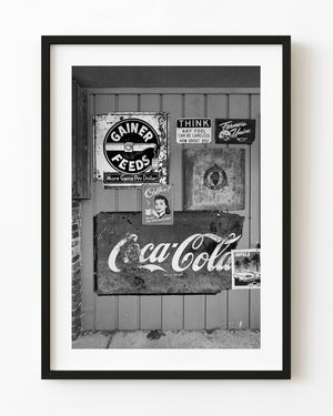 Black and white vintage Coca Cola sign on wooden wall
