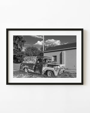 Weathered panel truck parked beside a building on Route 66