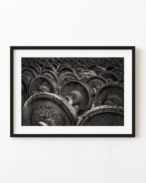 Rows of rusted railway wheels in black and white