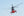 Colour aviation photograph of a red and grey Sea King in flight
