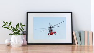Rescue helicopter in flight against a clear pale blue background