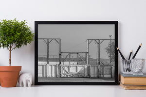Monochrome study of weathered timber and chain-link mesh at a Quebec rink