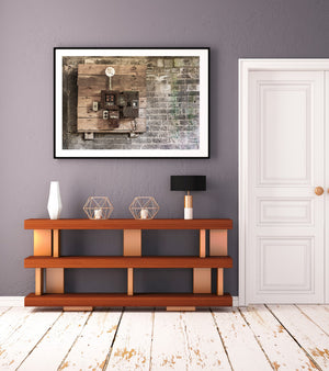 Textured brick wall beside a weathered wooden electrical mounting board