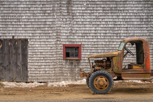 Rusted farm truck with exposed engine beside a shingled Ontario barn