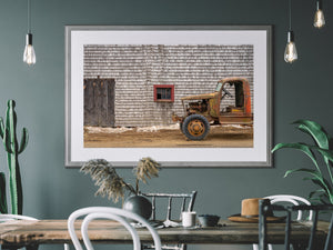 Historic farm vehicle by aged barn structure