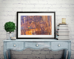 Faded graffiti layered over orange and purple rust textures