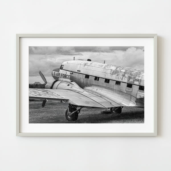 Abandoned U.S. Air Force plane with rusting fuselage in black and white