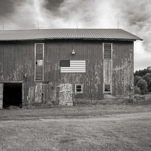 Weathered wood barn with patriotic flag display
