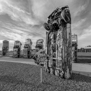 Graffiti covered VW Beetles buried nose down in gravel