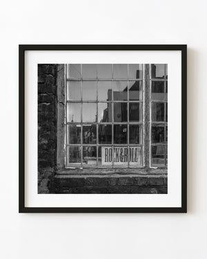 Black and white reflections in a weathered Rye bookstore window