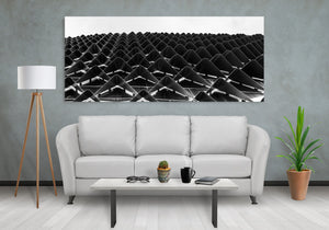 Abstract architectural pattern of dark triangles against a bright sky