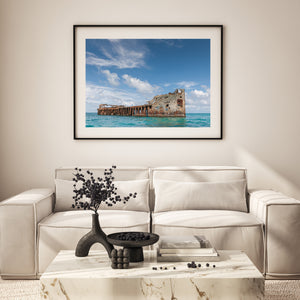 Wide view of the SS Sapona wreck and a broad tropical sky.