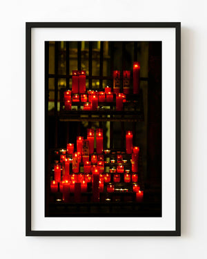 Glowing red votive candles at Sagrada Familia in Barcelona