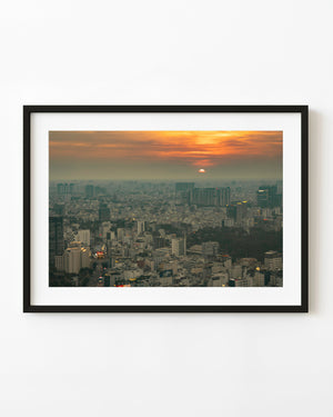 Orange sunset above the hazy Saigon skyline