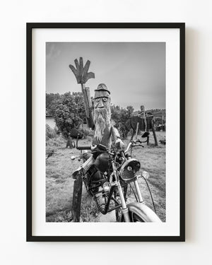 Wooden figure and motorcycle in Salem photographed in black and white