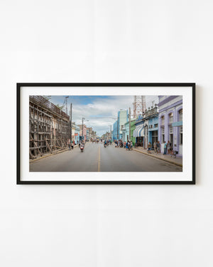 Colourful street scene with pedestrians and pastel building facades