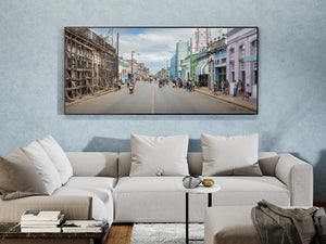 Wide street view with ornate facades and a softly clouded sky