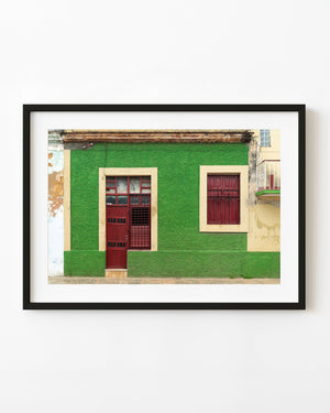Green facade and red wooden door in Santa Marta Cuba