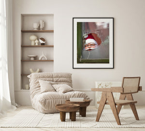 Jagged glass edges around a cheerful Santa display in Bucharest