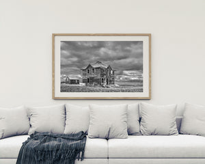 Monochrome Saskatchewan landscape with an abandoned house and small outbuilding