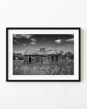 Abandoned Saskatchewan farmhouse in tall grass in black and white
