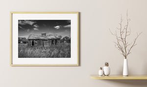 Weathered timber walls beneath scattered clouds in Saskatchewan