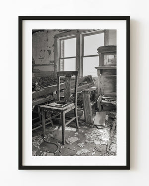 Old chair in an abandoned Saskatchewan schoolhouse in black and white