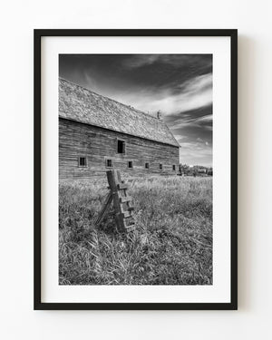 Saskatchewan prairie barn and leaning fence in black and white