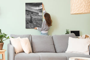 Rural architectural photograph with dark windows and streaked clouds