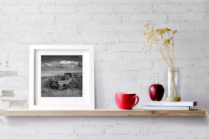Old truck relic in rural Saskatchewan wheat field under dramatic clouds