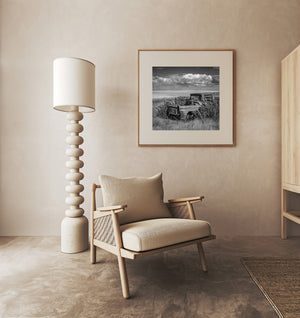 Vintage rusted truck in open Saskatchewan wheat field horizon