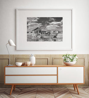 Black and white print of weathered schoolhouse and sky