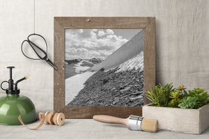 Bright snowbank textures contrasting with a steep rocky foreground