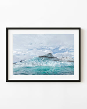 Sediment-layered Antarctic iceberg in turquoise water
