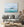 Textured pale blue iceberg above vivid turquoise water