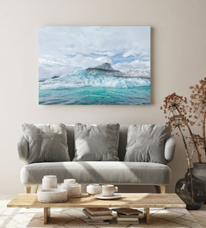 Textured pale blue iceberg above vivid turquoise water