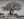 Massive baobab trunk and bare branching canopy against a pale sky