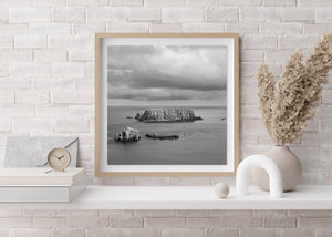 Steep island cliffs rising above quiet Northern Irish coastal water