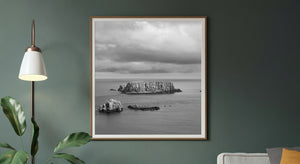 Black and white coastal scene with offshore rock formations