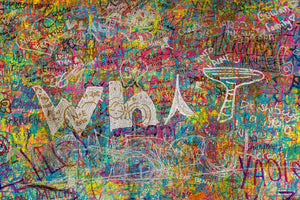 Large white letters and a cocktail-glass outline over vivid graffiti