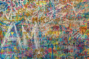Large white scrawls over layered turquoise pink and yellow paint
