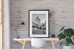 Historic Transylvanian architecture with an arch and covered wooden walkway