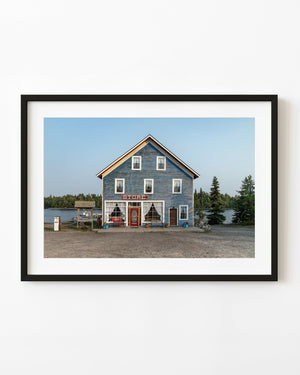 Blue general store beside the water at Silver Inlet