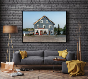 Quiet waterfront scene centred on a blue wooden general store