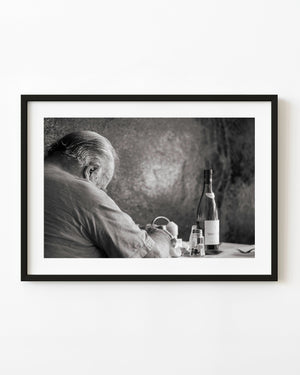 Sleeping man at a Buenos Aires restaurant table in monochrome