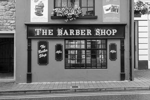 Traditional Irish barber shop with ornate lettering and gridded windows