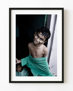 Smiling boy in an Indian doorway in a colour portrait