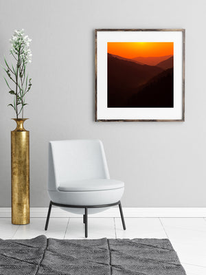 Warm orange light behind dark mountain silhouettes in the Smokies