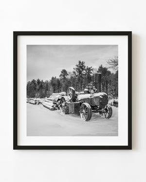 Snow-covered logging tractor in Haliburton in black and white