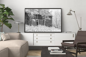 Black and white photograph of a Canadian barn in winter
